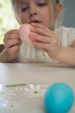 Little Girl Decorating Easter Eggs