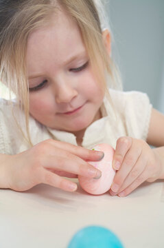 Little Girl Decorating Easter Eggs