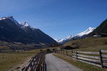 Kampl, Austria - March 16, 2023 - meadows and grasslands in an alpine valley Stubaital at the end of the winter season