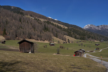 Kampl, Austria - March 16, 2023 - meadows and grasslands in an alpine valley Stubaital at the end of the winter season