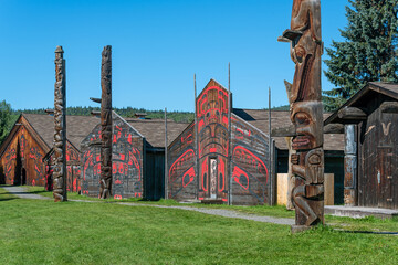 Traditional long houses and totem poles of the Gitxsan or Ksan First Nations natives, Old Hazelton,...