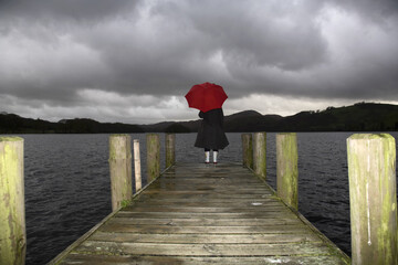 Girl on Dock in Rain, Lake Windermere, Cumbria, England