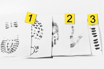 A4 sheets with various shoe and handprints. Collected from the crime scene. For the crime lab. And investigation.