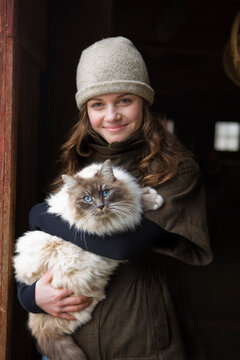 Portrait of a Teenage Girl Holding a Cat on a Farm in Hillsboro, Oregon, USA