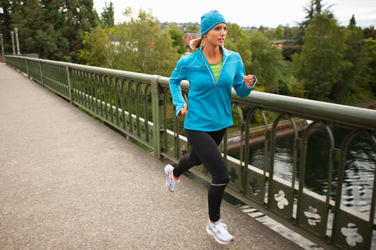 Woman Jogging across Bridge, Seattle, Washington, USA