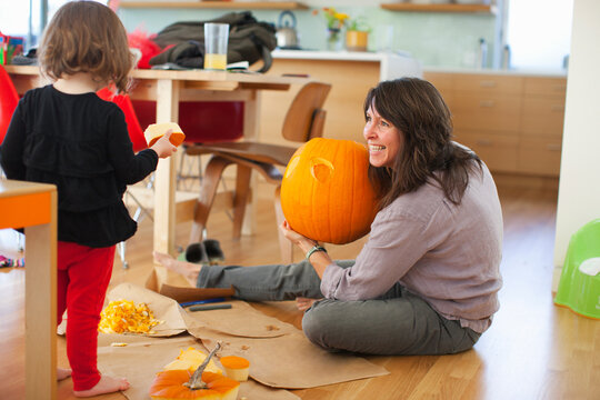 Girl and Mother Carving Pumpkin, Portland, Multnomah County, Oregon, USA