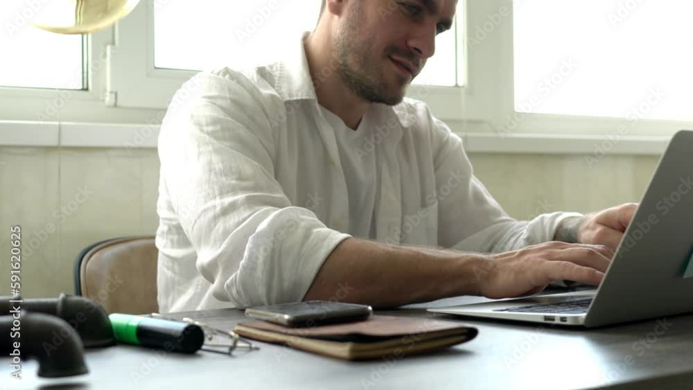 Poster skilled freelancer checking received notification on mobile device while doing distance web project 