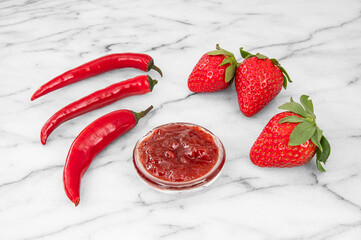 Close-up of strawberries and homemade jam with red peppers