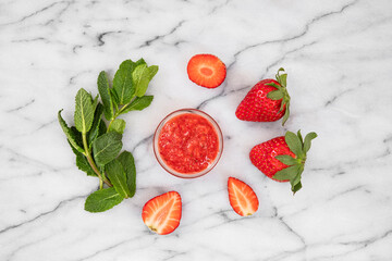 Close-up of strawberries and homemade jam with fresh mint