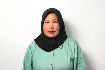 Middle aged Asian women wearing hijab looking at camera