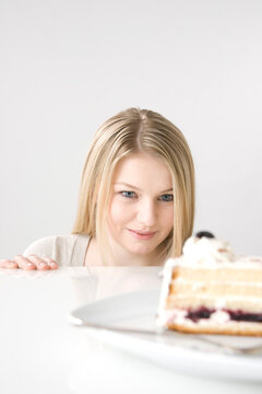 Woman Staring at Piece of Cake