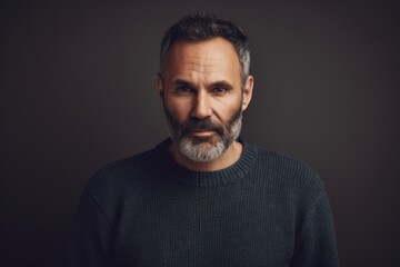 Fototapeta premium Portrait of a handsome middle-aged man with grey hair and beard