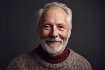 Obraz premium Portrait of a senior man in a sweater on a dark background