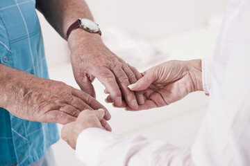 Close-up of Caregiver holding Patient's Hands