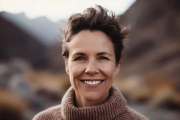 Abwaschbare Fototapete Lachsfarbe Close-up portrait photography of a grinning woman in her 40s wearing a cozy sweater against a mountain landscape background. Generative AI