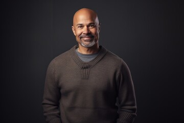 Obraz premium Portrait of a happy african american man on black background