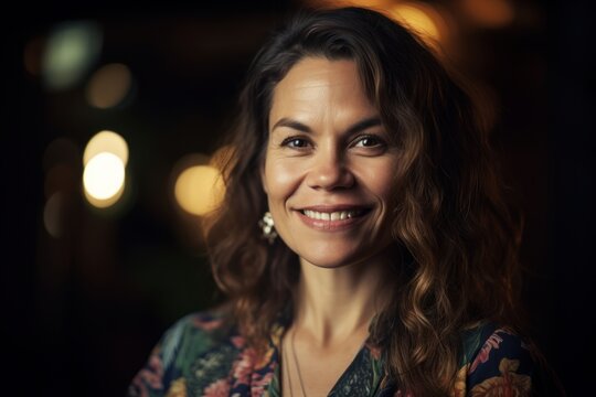 Portrait of a beautiful woman in a cafe on a dark background