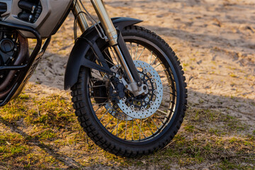 Fototapeta na wymiar Enduro type motorcycle front wheel side view of disks and brakes