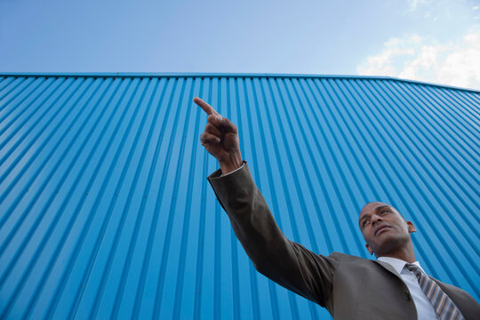 Portrait of Businessman Pointing, Mannheim, Baden-Wurttemberg, Germany