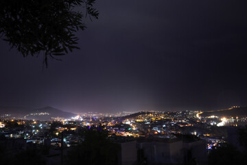 Fototapeta na wymiar Dark cityscape and lights after rain at evening.