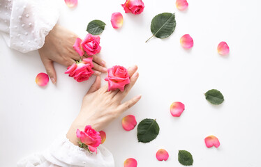 Beauty hands woman with rose flowers are on the table. Natural cosmetic for hand skin care. Fashion makeup