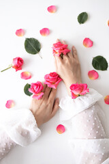 Beauty hands woman with rose flowers are on the table. Natural cosmetic for hand skin care. Fashion makeup