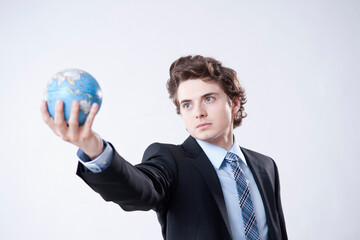 Portrait of Young Businessman holding World Globe