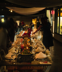 View of table set for formal party in dimly lit room