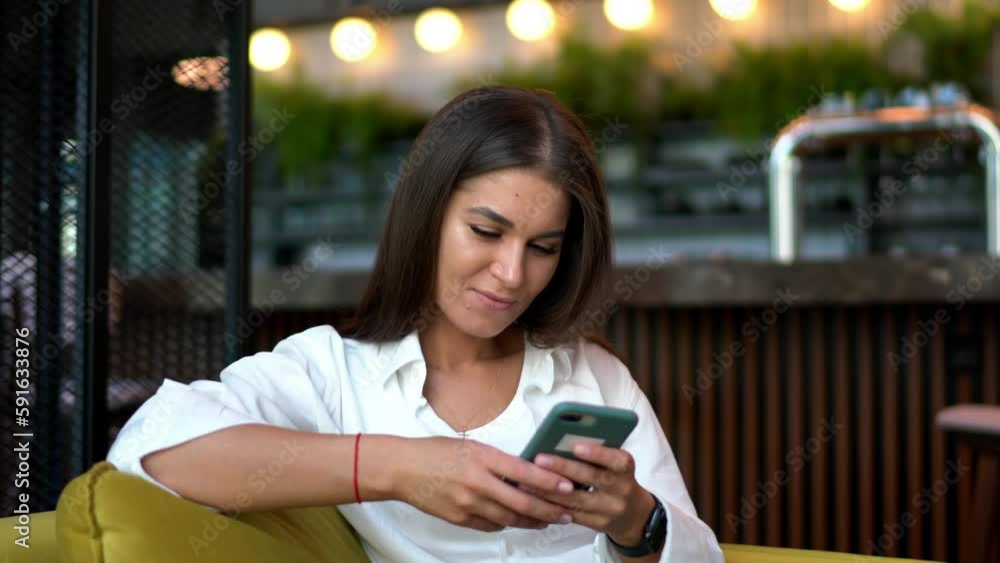 Poster cheerful hipster girl installing media application for browsing social networks during free time, ha