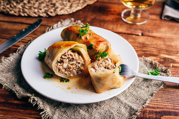 Sliced Cabbage Rolls Stuffed with Minced Beef and Rice on White Plate Served with Chopped Parsley