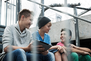Boys with Tablet Sitting on Bleachers, Mannheim, Baden-Wurttemberg, Germany