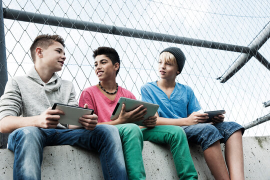 Boys with Tablets and Video Games in Playground, Mannheim, Baden-Wurttemberg, Germany