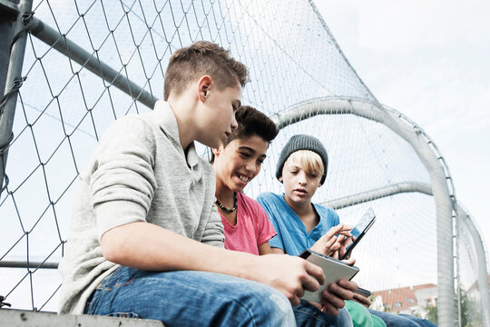 Boys with Tablets and Video Games in Playground, Mannheim, Baden-Wurttemberg, Germany