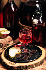 Homemade red currant nalivka and chocolate with apple