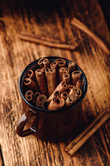 Cinnamon sticks in a metal mugr