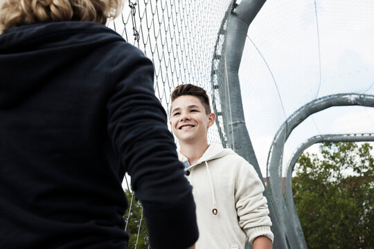 Girl and Boy Talking in Playground, Mannheim, Baden-Wurttemberg, Germany