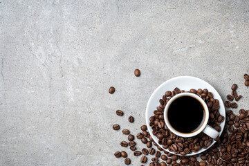Cup of coffee with coffee beans on gray stone background. Top view - 591634616