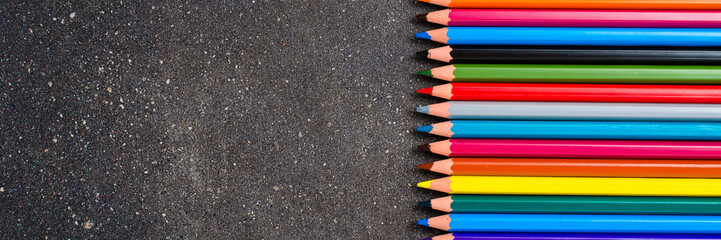 Colorful pencils on dark table - 591634675