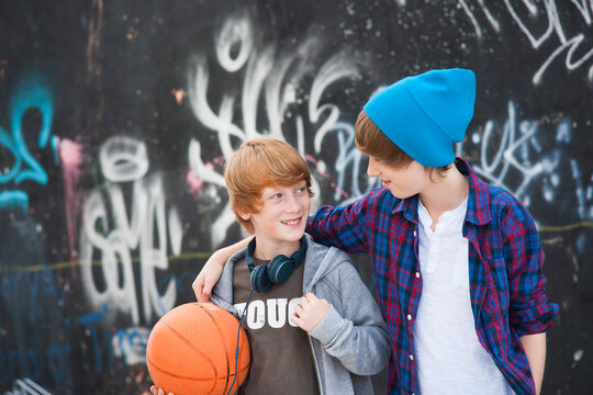 Boys with Basketball by Graffiti Covered Wall, Mannheim, Baden-Wurttemberg, Germany