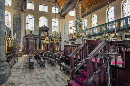 Portuguese Synagogue (or the Esnoga, or Snoge, 1675) in Amsterdam. Beautiful interior of Portuguese Synagogue with golden magnificent chandeliers. AMSTERDAM, The NETHERLANDS. April 3, 2023.