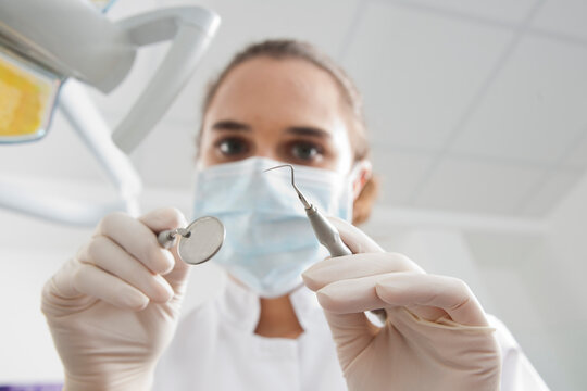 Close-up of Dental Instruments held by Dentist in Dental Office, Germany