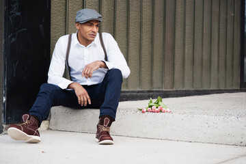 Portrait of Man Sitting on Step with Flowers, Mannheim, Baden-Wurttemberg, Germany