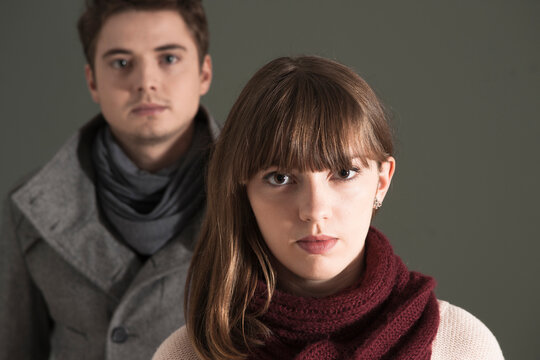 Close-up, Head and Shoulder Portrait of Young Couple Looking at Camera, Studio Shot on Grey Background