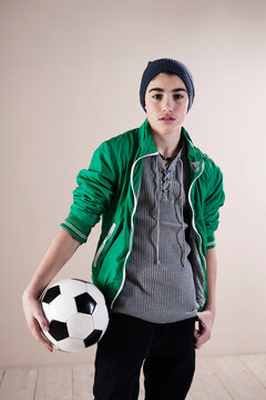Portrait of Boy with Soccer Ball in Studio