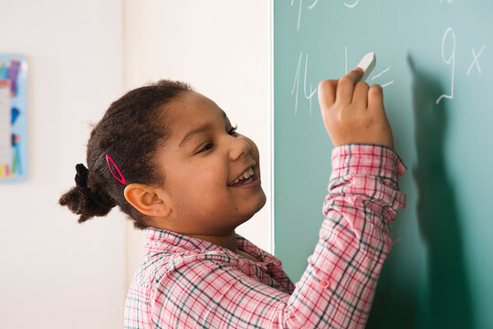 Girl Answering Question at Blackboard in Classroom, Baden-Wurttemberg, Germany