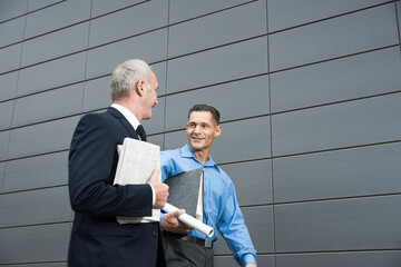 Businessmen Walking and Talking Outdoors, Mannheim, Baden-Wurttemberg, Germany