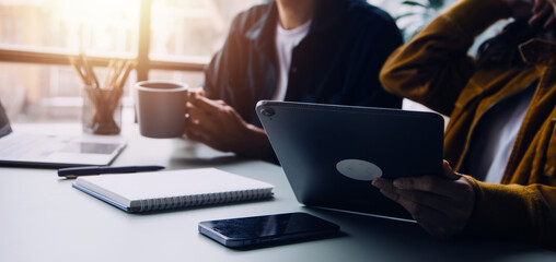 Group of confident business people point to graphs and charts to analyze market data, balance sheet, account, net profit to plan new sales strategies to increase production capacity.