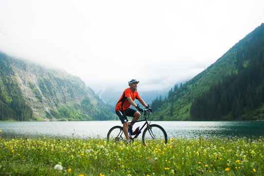 Mature Man Riding Mountain Bike by Vilsalpsee, Tannheim Valley, Tyrol, Austria