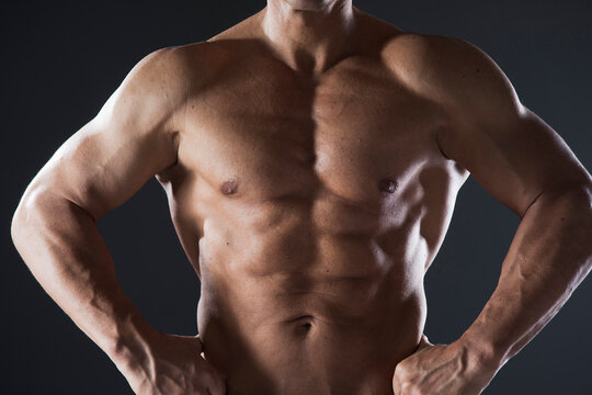 Close-up of Muscular Man's Chest and Arms, Studio Shot