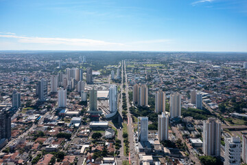 Fototapeta na wymiar Aerial view of Afonso Pena avenue in the center of Campo Grande with a view of the park of powers and park of indigenous nations in the background, MS, Brazil